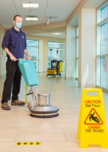 ServiceMaster Clean employee buffing a tile floor